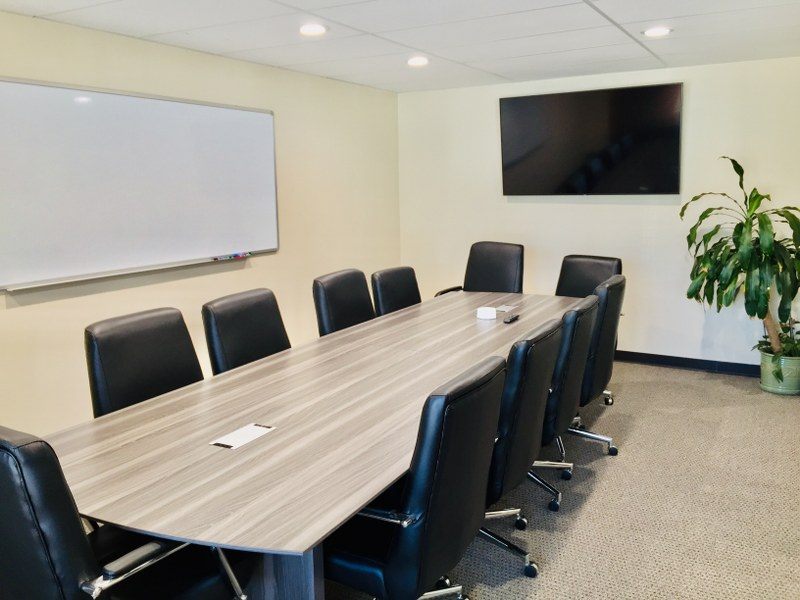 10-seat boardroom with long table, TV and whiteboard at Zipdesk