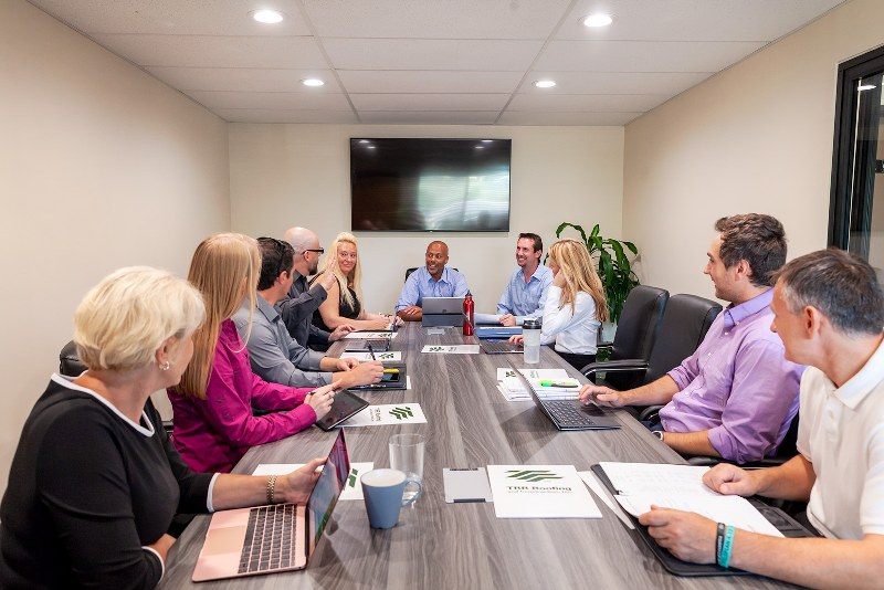 Team meeting around the conference table at Zipdesk, Centennial