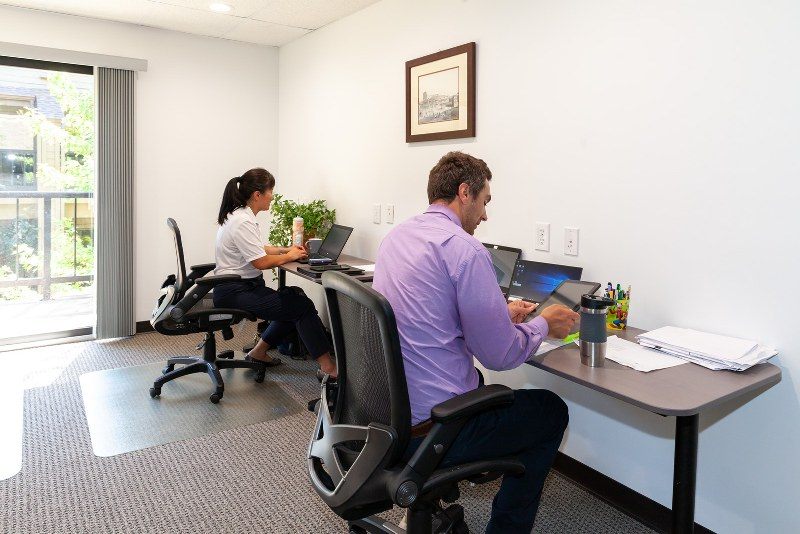 Two people working in a furnished private office at Zipdesk, Centennial