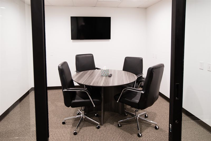 4-seat meeting room with round table and TV at Zipdesk